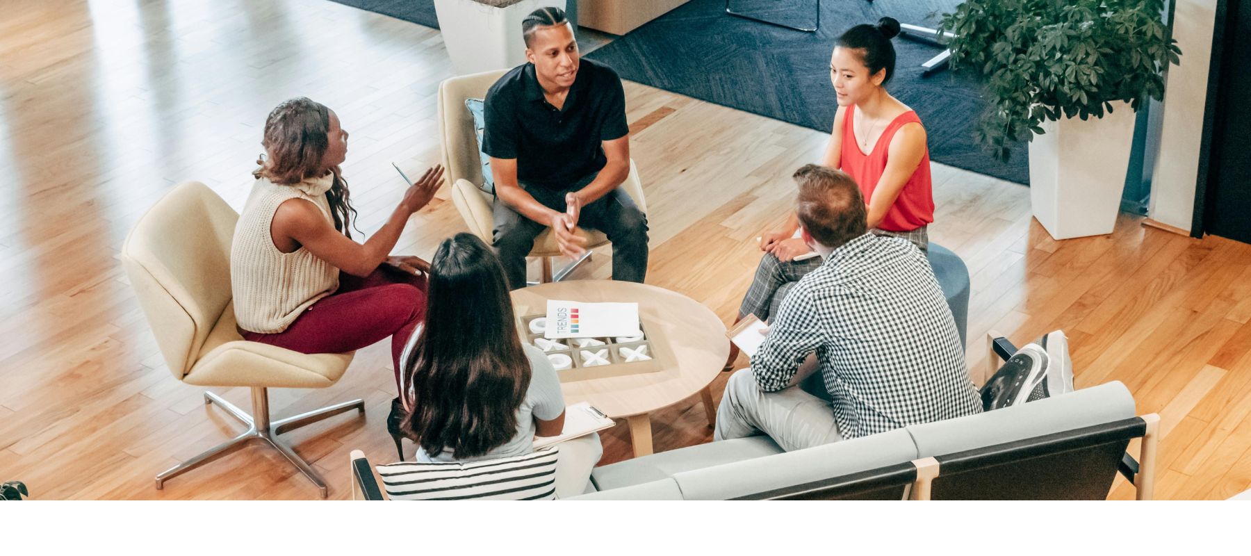 Team in a relaxed office setting brainstorming collaboratively, symbolizing the role of soft skills in workplace success across UAE, Saudi Arabia, and global markets